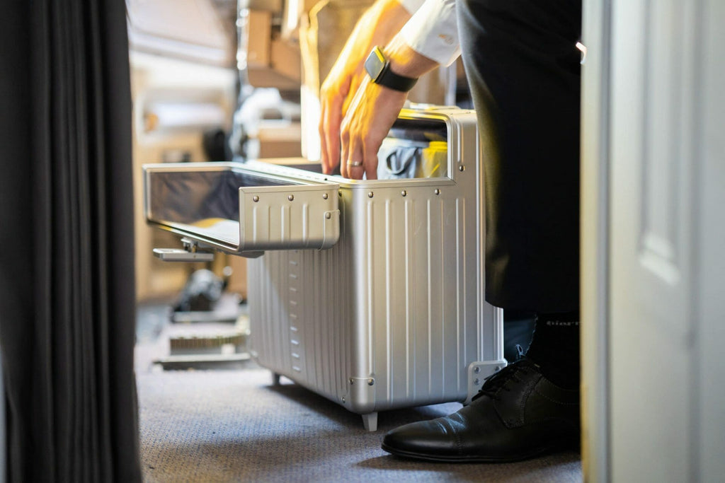 Pilot-case-aluminum-silver|Open platinum silver Aleon pilot case crafted from air craft grade aluminum|Aluminum pilot case with telescoping handle and full length piano hinge or unmatched durability|Silver pilot case with hands free carrying strap|Aluminum Pilots Case open and silver and black|Aluminum Pilots Case handle extended|Aluminum-pilotcase-silver-front-with-piano-hinges video overview|Alu