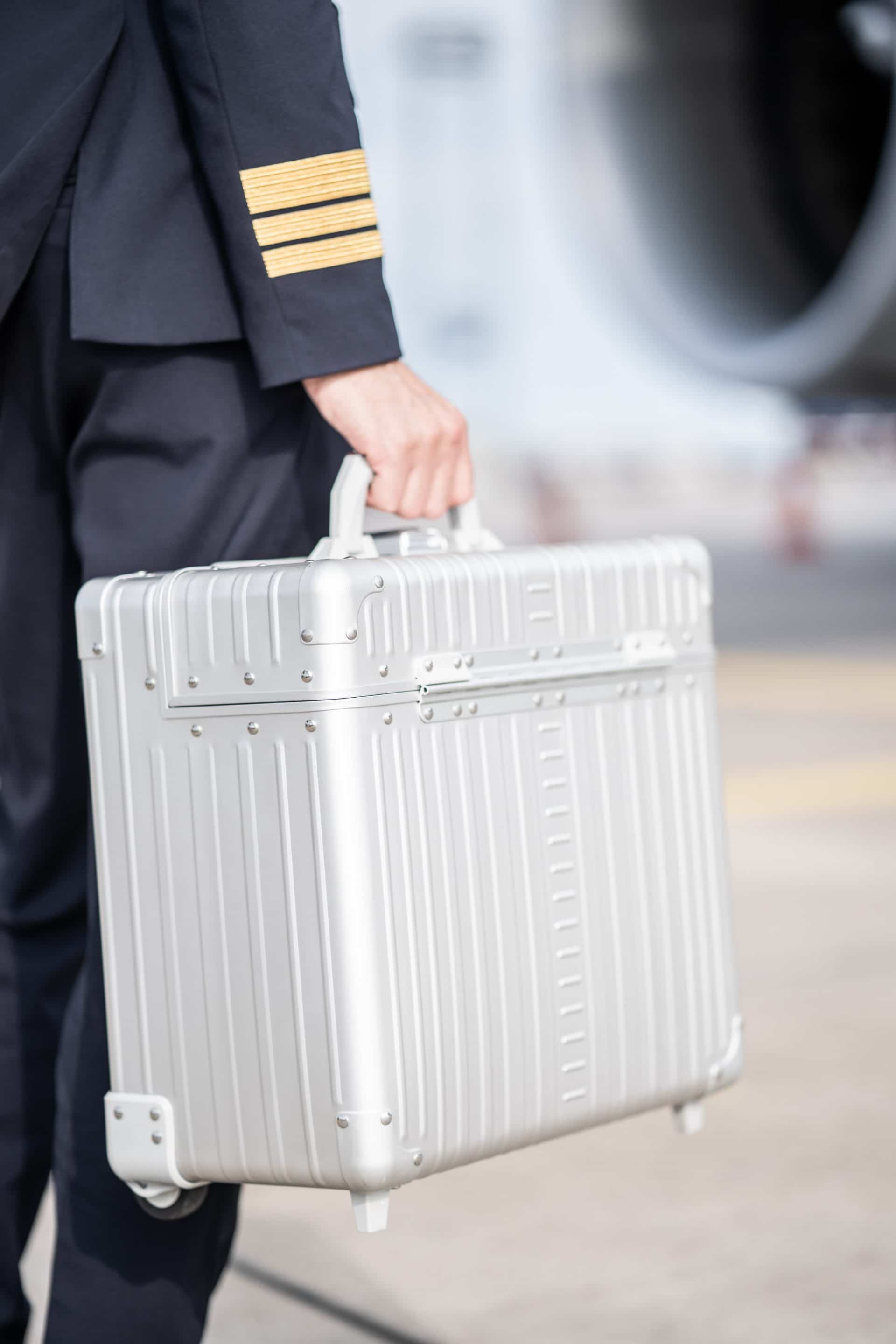 Pilot-case-aluminum-silver|Open platinum silver Aleon pilot case crafted from air craft grade aluminum|Aluminum pilot case with telescoping handle and full length piano hinge or unmatched durability|Silver pilot case with hands free carrying strap|Aluminum Pilots Case open and silver and black|Aluminum Pilots Case handle extended|Aluminum-pilotcase-silver-front-with-piano-hinges video overview|Alu