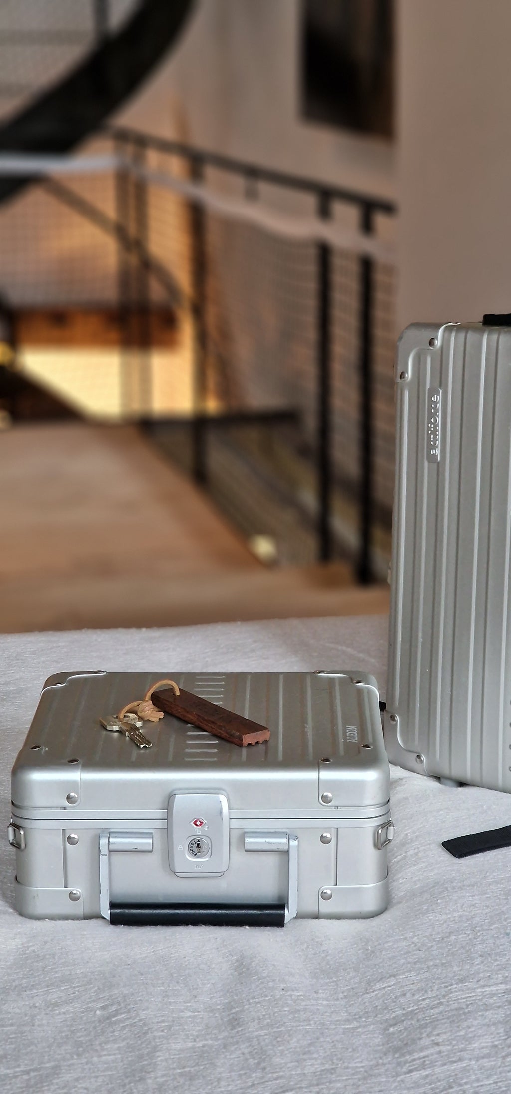 Aleon 10-inch silver aluminum messenger case carried with removable shoulder strap, stylish and durable for travel or work