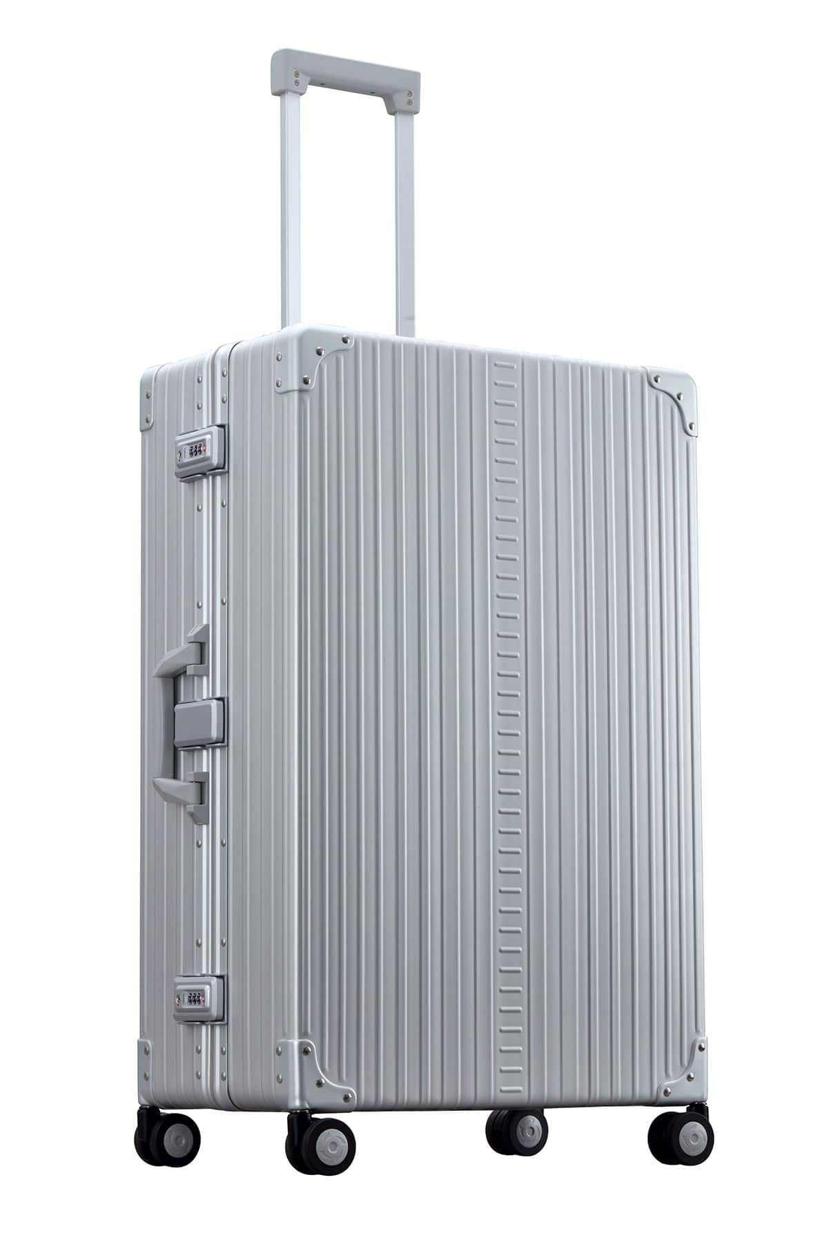 30″-Macro-Traveler-silver-aluminum-wheeled-luggage|ALEON silver Macro Traveler Checked Case in brushed aluminum finish, standing upright with reinforced corners and dual lock latches, showcasing its sleek and durable design.|ALEON silver platinum Macro Traveler Checked Case open to reveal organized interior with compression straps and a zippered divider, ensuring secure storage for travel essentia