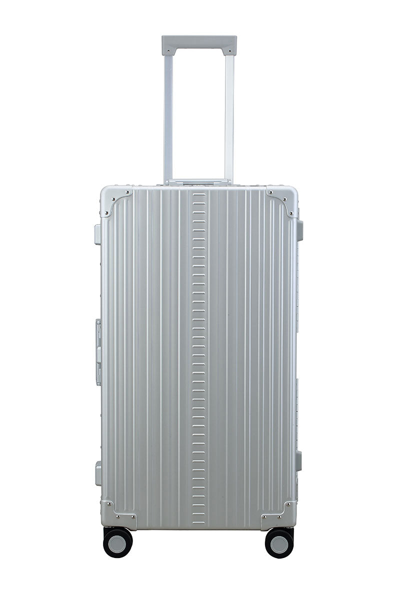 Silver Platinum 30-inch Aluminum Trunk – International Checked Spinner Case|A close-up of the silver suitcase’s high-density double quad wheels, designed for smooth 360-degree rotation. The aluminum side handle is visible, offering an alternative carrying option for convenience.|The platinum suitcase is fully opened, revealing a spacious interior with a fitted packing cube and a compression panel 