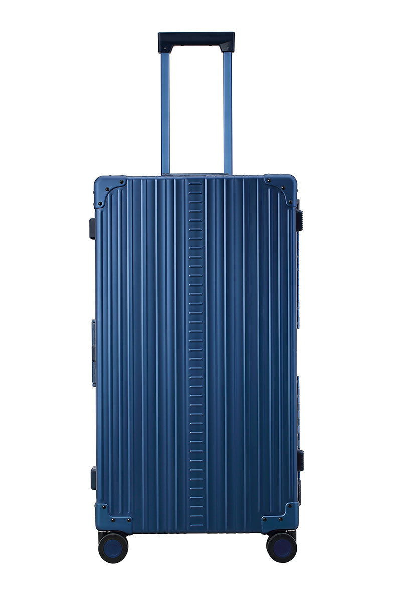 Sharpie Blue 30-inch Aluminum Trunk – International Checked Spinner Case|A close-up of the sapphire suitcase’s high-density double quad wheels, designed for smooth 360-degree rotation. The aluminum side handle is visible, offering an alternative carrying option for convenience.|The blue suitcase is fully opened, revealing a spacious interior with a fitted packing cube and a compression panel desig