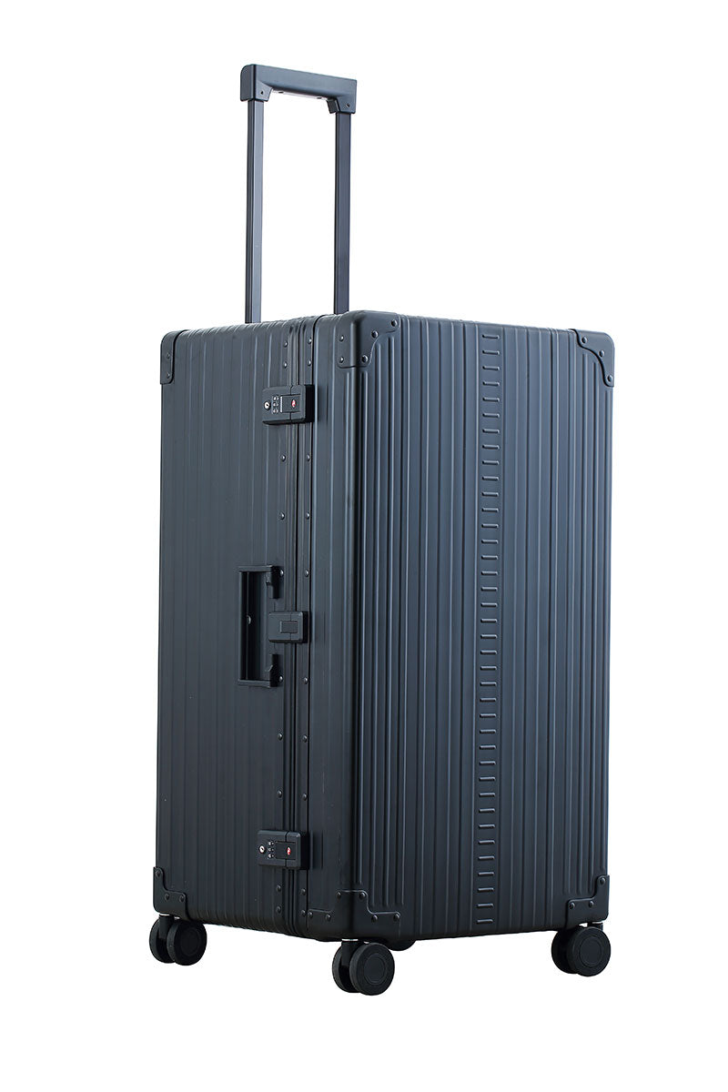 Sleek Onyx Black Aluminum Trunk – Durable 30-inch Checked Luggage|A close-up of the onyx suitcase’s high-density double quad wheels, designed for smooth 360-degree rotation. The aluminum side handle is visible, offering an alternative carrying option for convenience.|The black suitcase is fully opened, revealing a spacious interior with a fitted packing cube and a compression panel designed to kee