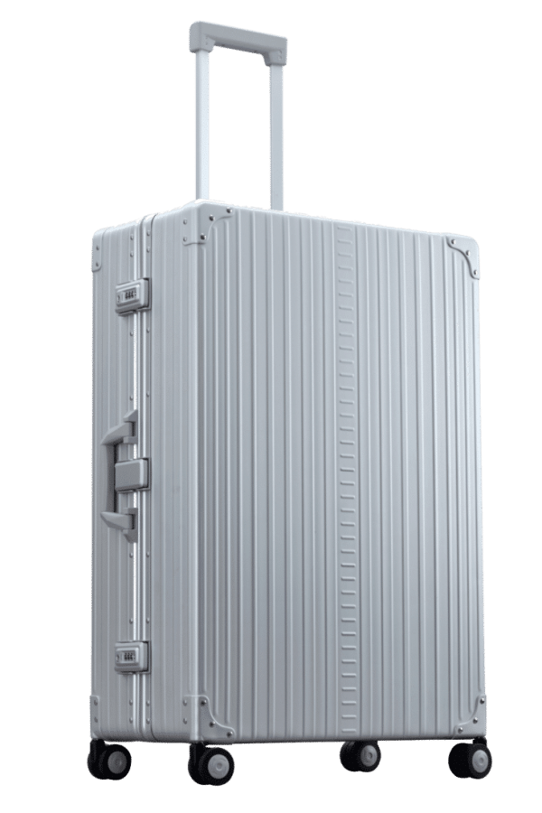 Side front profile of Aleon 32" Checked Luggage made for long trips with durable aluminum exterior||||The ALEON 32″ Macro Plus Traveler, with its brushed aluminum finish, leans against a baggage claim carousel. Its sleek exterior catches ambient lighting, showcasing its premium craftsmanship and refined design built for sophisticated travelers.|Bronze|Onyx Blank Aluminum Luggage Color|Aluminum lug