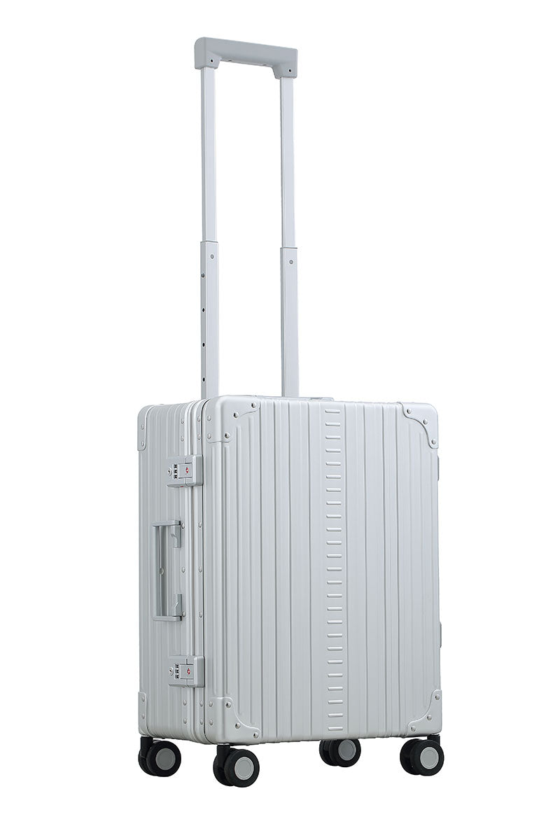 Aleon carry on with suiter in platinum color|Side view of Aleon carryon with suiter in silver|ALEON silver Carry-On with Suiter open to reveal a thoughtfully designed interior, featuring compression straps, a zippered divider, and a fold-out suiter for wrinkle-free garment storage.|Lock view of Aleon carry on equipped with TSA approved locks|26 inch aluminum checked suitcase with wheels||silver ch