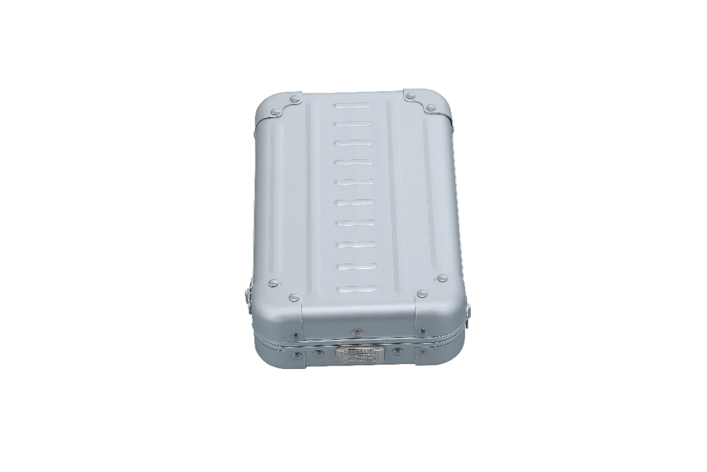 Open cross body case made with aluminum|ALEON vertical crossbody case displayed with highlighted features, including double reinforced aluminum corners for enhanced durability and an aluminum clasp for secure closure. The case is open, revealing organized interior compartments. Brand name 'ALEON' and tagline 'TIMELESS BY DESIGN. BUILT TO LAST.' are shown at the top right.|Aleon vertical crossbody 