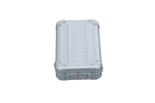 Open cross body case made with aluminum|ALEON vertical crossbody case displayed with highlighted features, including double reinforced aluminum corners for enhanced durability and an aluminum clasp for secure closure. The case is open, revealing organized interior compartments. Brand name 'ALEON' and tagline 'TIMELESS BY DESIGN. BUILT TO LAST.' are shown at the top right.|Aleon vertical crossbody 