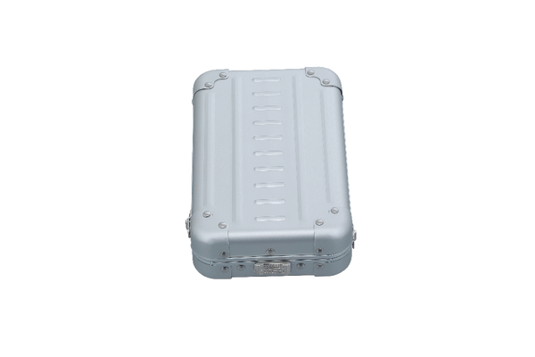 Open cross body case made with aluminum|ALEON vertical crossbody case displayed with highlighted features, including double reinforced aluminum corners for enhanced durability and an aluminum clasp for secure closure. The case is open, revealing organized interior compartments. Brand name 'ALEON' and tagline 'TIMELESS BY DESIGN. BUILT TO LAST.' are shown at the top right.|Aleon vertical crossbody 