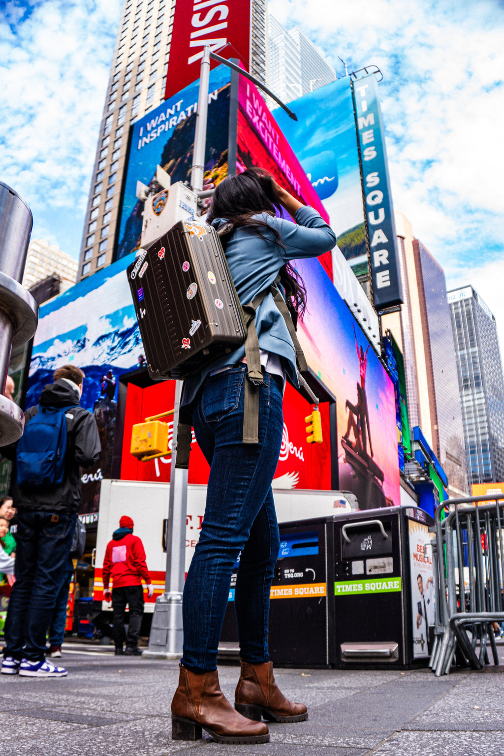 Aleon Bronze aluminum backpack in lifestyle travel or commuting scene through New York