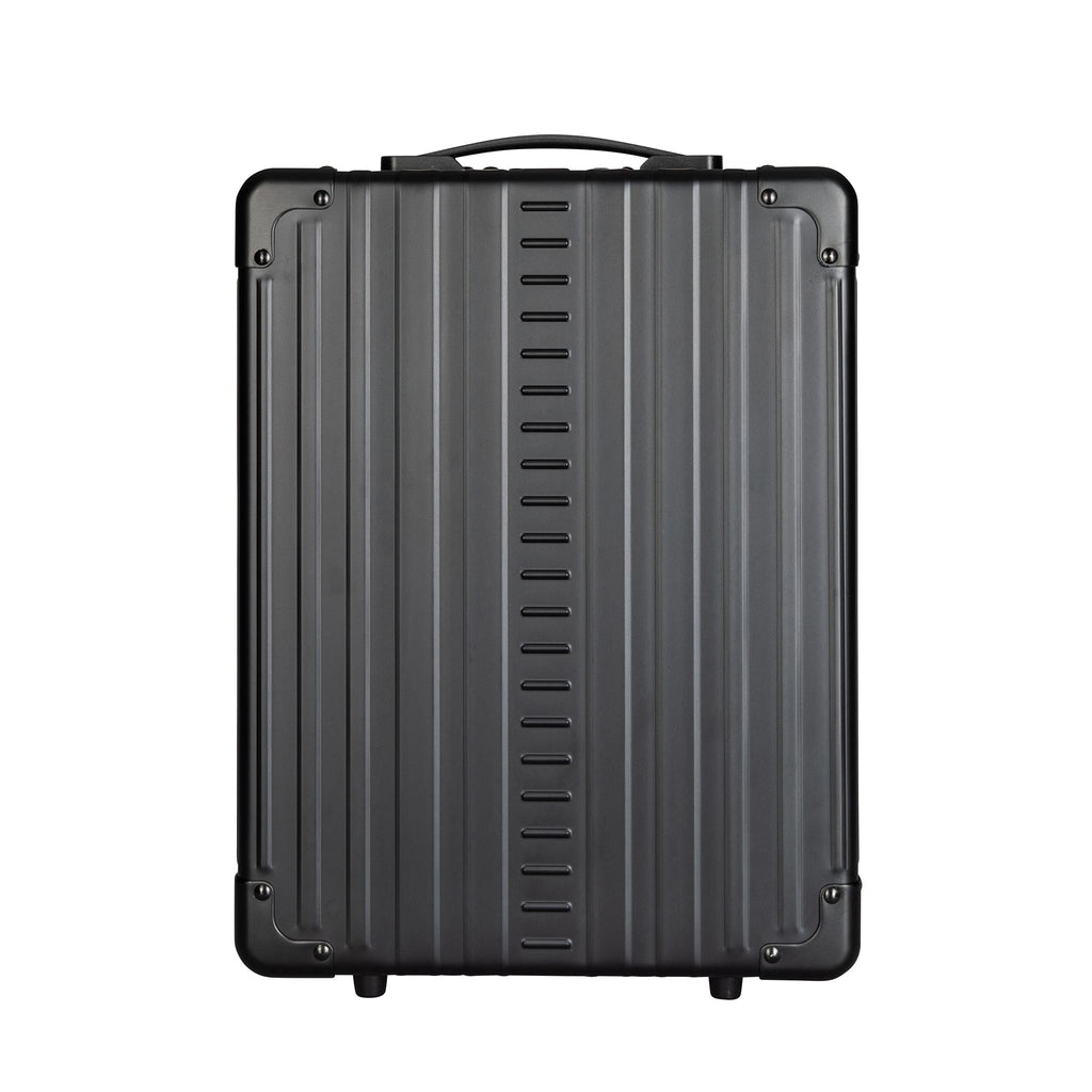 A sleek, matte black, hard-shell carry-on suitcase stands upright, showcasing its ridged design and durable construction.
