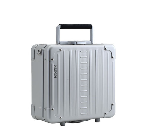 aleon-silver-beauty-case-10-inches|ALEON Platinum Silver Messenger Case with features highlighted. The case includes a plastic-lined pocket for keeping belongings protected and clean, a removable packing cube for better organization on the go, and a TSA-approved key lock to keep essentials safe and secure. The case is open, showing the interior design and compartments. The image has an orange bord