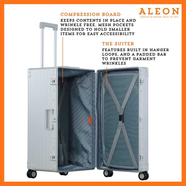 The platinum suitcase is fully opened, revealing a spacious interior with a fitted packing cube and a compression panel designed to keep belongings secure and wrinkle-free. The seamless rubber seal lining ensures protection against moisture and dust.