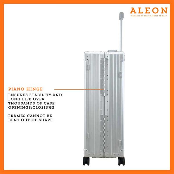 The ALEON 32″ Macro Plus Traveler, with its brushed aluminum finish, leans against a baggage claim carousel. Its sleek exterior catches ambient lighting, showcasing its premium craftsmanship and refined design built for sophisticated travelers.