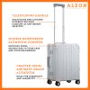 The ALEON 21" Carry-On rests beside a plush airport lounge chair, its refined metallic finish complementing the sophisticated travel setting. Designed for durability and elegance, it exudes premium craftsmanship and functionality.