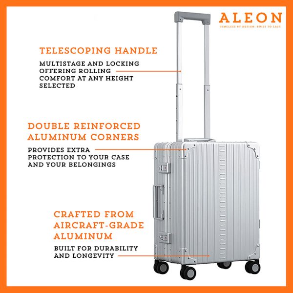 The ALEON 21" Carry-On rests beside a plush airport lounge chair, its refined metallic finish complementing the sophisticated travel setting. Designed for durability and elegance, it exudes premium craftsmanship and functionality.