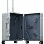trunk style carry on suitcase made with aluminum and has a garment holder