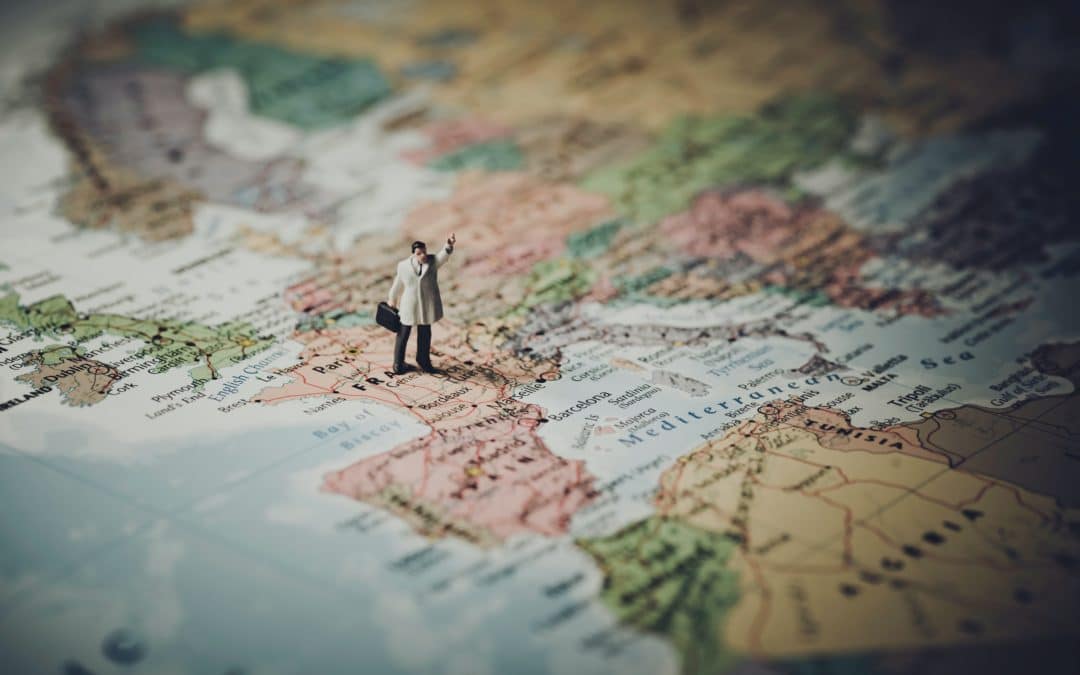 guy on map looking for places to travel in Europe