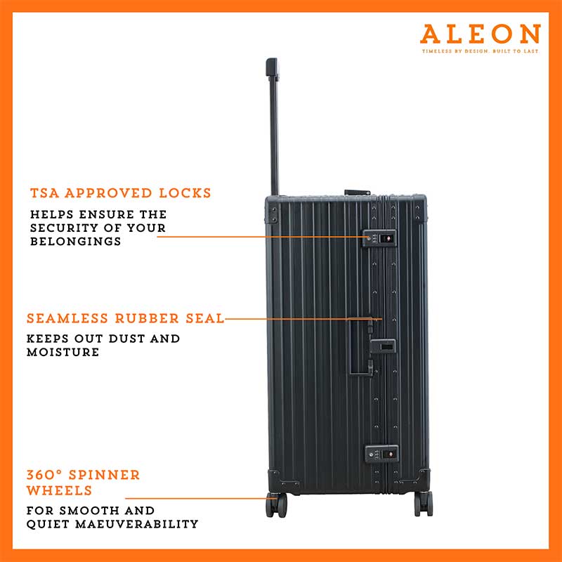 3019-ON--B075XZK3J4-lock-1-(1) A sleek, onyx-colored aluminum trunk-style suitcase with reinforced corners and a sturdy telescoping handle. The case stands upright, showcasing its durable construction and TSA-approved combination locks.