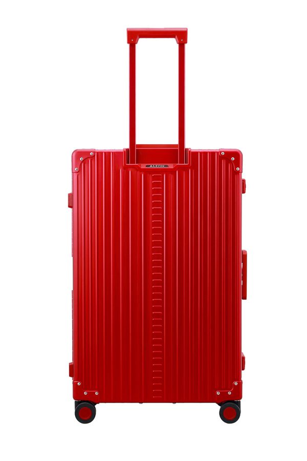 Back view of Ruby Red Aleon checked aluminum luggage highlighting smooth-rolling wheels and sleek design.