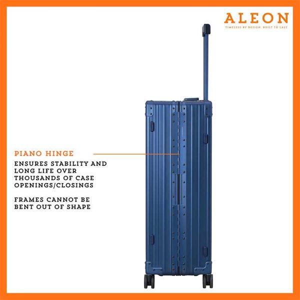 The ALEON 32″ Macro Plus Traveler, with its brushed aluminum finish, leans against a baggage claim carousel. Its sleek exterior catches ambient lighting, showcasing its premium craftsmanship and refined design built for sophisticated travelers.