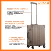 A polished aluminum ALEON 21" Carry-On stands upright on a glossy airport floor, reflecting ambient lighting. Its durable, hard-shell construction and smooth wheels embody modern travel efficiency.