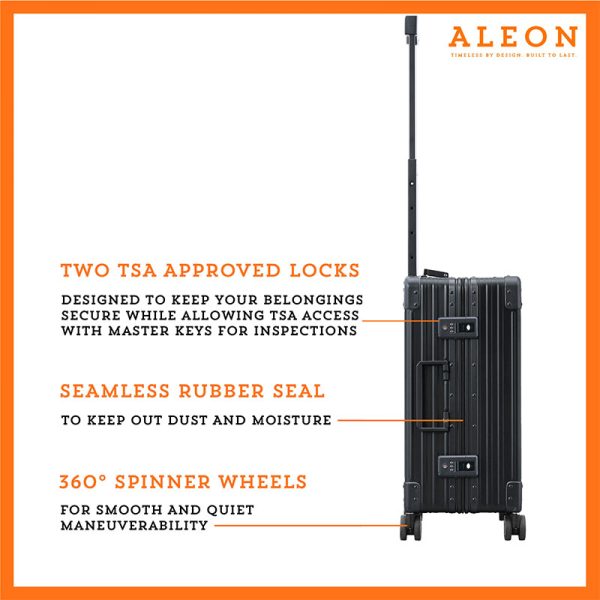 The ALEON 21" black Carry-On rests beside a plush airport lounge chair, its refined metallic finish complementing the sophisticated travel setting. Designed for durability and elegance, it exudes premium craftsmanship and functionality.