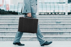 How you should carry a briefcase, man in suit with right hand holding at his side