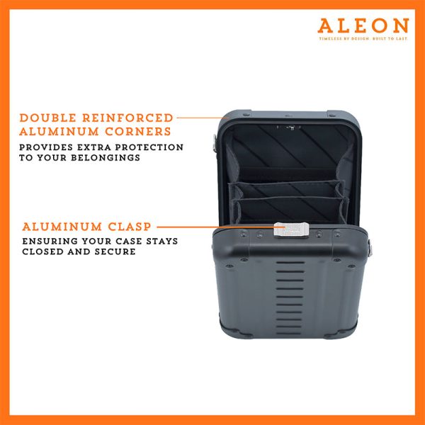 ALEON vertical crossbody case displayed with highlighted features, including double reinforced aluminum corners for enhanced durability and an aluminum clasp for secure closure. The case is open, revealing organized interior compartments. Brand name 'ALEON' and tagline 'TIMELESS BY DESIGN. BUILT TO LAST.' are shown at the top right.