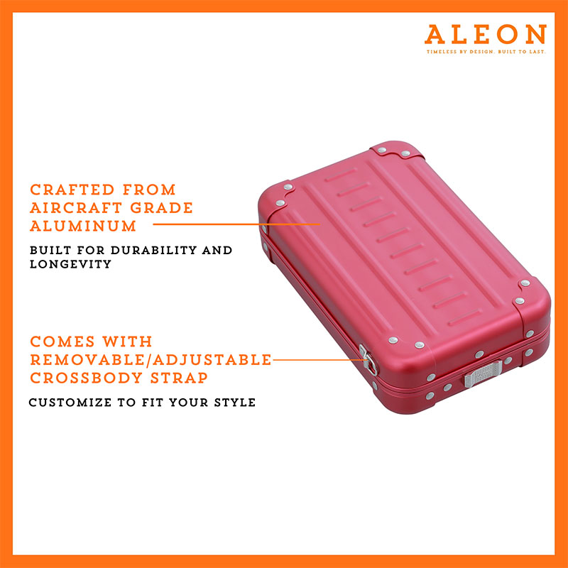 1905-V-RU Aleon vertical crossbody bag designed with aircraft-grade aluminum for lasting durability. The bag features an adjustable and removable strap for personalized styling. Aleon logo and tagline 'Timeless by design. Built to last.' are prominently displayed against a clean white background accented with orange borders.