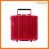 The image features a red ruby ALEON Messenger Case with a sleek, modern design. Vertical ridges run across the aluminum exterior, reinforced with metal rivets at the corners for durability. A black handle sits at the top, complementing the case’s bold aesthetic. The ALEON logo is printed in white on the left side, reinforcing brand identity. The case is set against a white background with an orange border, and the top right corner displays the ALEON logo alongside the tagline, "Timeless by design. Built to last."